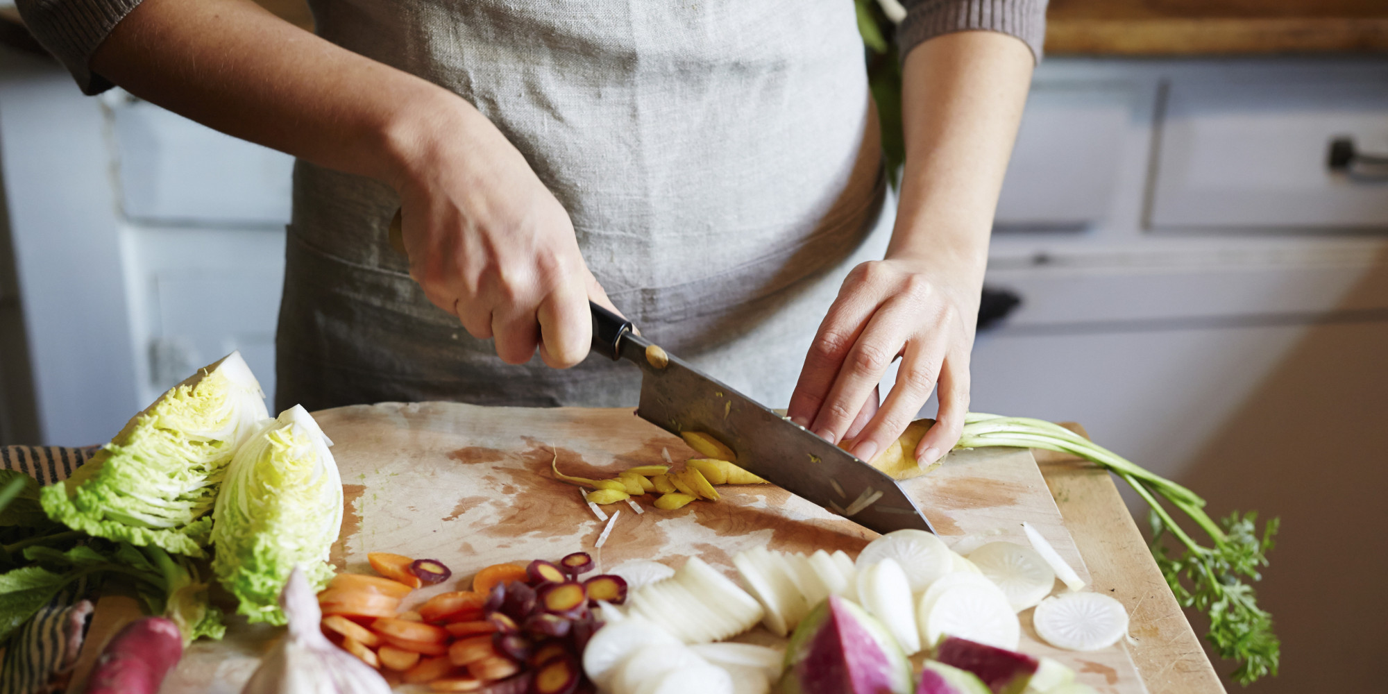 R Man cooking in kitchen with ingredients around her